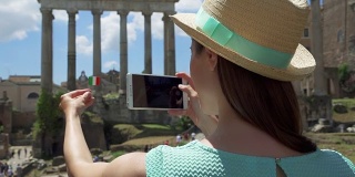 一名女子在罗马广场附近用手机拍照。女游客在罗马广场拍照