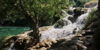 slow move of strong cascade waterfall falls in mountain river