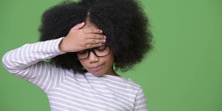 年轻可爱的非洲女孩与非洲发型头痛