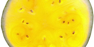 令人惊叹的俯视图，整个一片黄色的西瓜，旋转的白色背景与背光顺时针靠近。