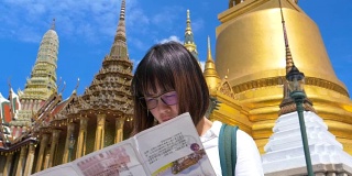 年轻的女游客探索城市地图，而旅行在泰国曼谷
