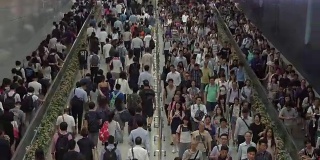 在香港的交通高峰期，一群步行上下班的人在香港火车站