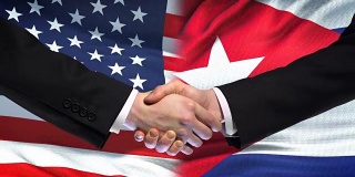 美国和古巴握手，国际友谊，旗帜背景